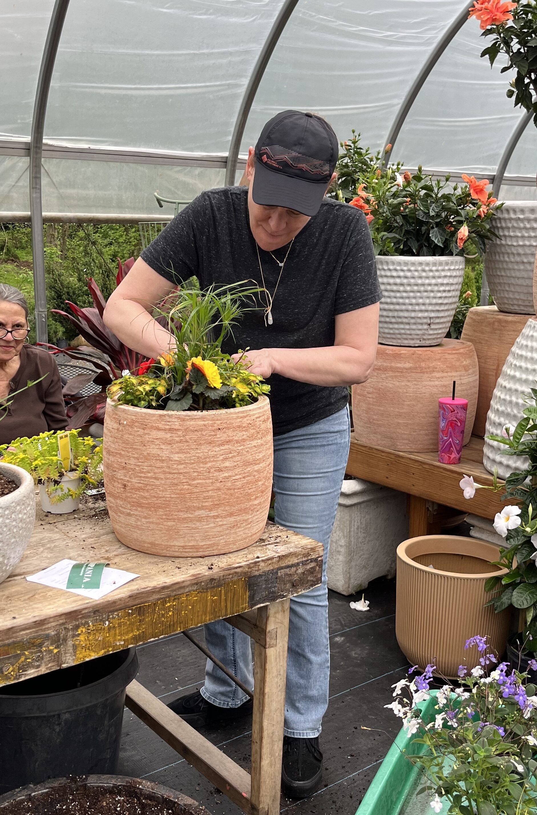 woman working on a summer planter